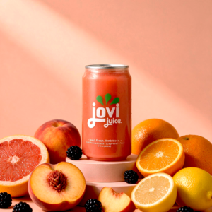 Sunset Glow Jovi Juice, surrounded by grapefruits, Blackberries, Peaches, Oranges and Lemons